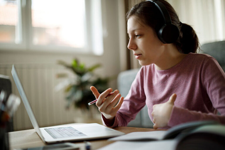 Woman At Laptop With Headphones