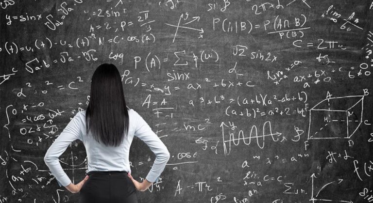 Woman at blackboard full of equations